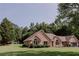 Attractive single-story brick home featuring manicured landscaping and a well-maintained lawn at 180 Jay Trl, Fayetteville, GA 30215