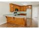Spacious eat-in kitchen features wood cabinets, granite countertops, and modern black appliances at 180 Jay Trl, Fayetteville, GA 30215