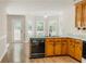 Kitchen featuring wood cabinets, granite countertops, and modern black appliances at 180 Jay Trl, Fayetteville, GA 30215
