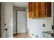 View of the laundry room features wood cabinets, utility sink, and access to a hallway at 180 Jay Trl, Fayetteville, GA 30215