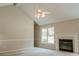 Bright living room featuring vaulted ceiling, fireplace and neutral color palette at 180 Jay Trl, Fayetteville, GA 30215