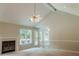 Cozy living room with fireplace, windows and hardwood flooring, perfect for relaxing or entertaining at 180 Jay Trl, Fayetteville, GA 30215