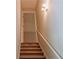 Carpeted staircase with white railing and neutral walls offers access to other floors at 180 Jay Trl, Fayetteville, GA 30215