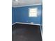 This bedroom is showcased with blue walls, vinyl floors, natural light, and a ceiling fan at 3072 Will Rogers Se Pl, Atlanta, GA 30316