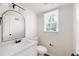Clean bathroom featuring a new vanity, stylish mirror, and window at 464 Rockborough Ter, Stone Mountain, GA 30083