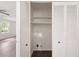 Open closet features bi-fold doors, shelves and dark wood flooring at 464 Rockborough Ter, Stone Mountain, GA 30083