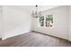 Dining room featuring a modern chandelier, large window, and wood floors at 464 Rockborough Ter, Stone Mountain, GA 30083