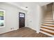 Inviting entryway with hardwood floors, staircase, and a wooden front door at 464 Rockborough Ter, Stone Mountain, GA 30083