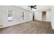 Bright living room with three windows, wood floors, and ceiling fan at 464 Rockborough Ter, Stone Mountain, GA 30083