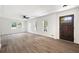 Spacious living room with hardwood floors, large windows, and a ceiling fan at 464 Rockborough Ter, Stone Mountain, GA 30083