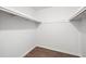Bright walk-in closet features hardwood floor and built-in white shelving at 464 Rockborough Ter, Stone Mountain, GA 30083