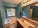 Bathroom featuring double sinks, large mirror, soaking tub and shower at 2105 Windy Oak Ct, Lithia Springs, GA 30122