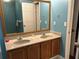 Bathroom featuring double sinks and large mirror at 2105 Windy Oak Ct, Lithia Springs, GA 30122