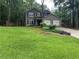 Charming home exterior showcasing a lush lawn and a two-car garage at 2105 Windy Oak Ct, Lithia Springs, GA 30122