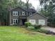 Charming two-story home featuring an attached two-car garage and a lush green lawn at 2105 Windy Oak Ct, Lithia Springs, GA 30122