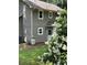 Exterior view of the home featuring a white door and blooming shrubbery at 2105 Windy Oak Ct, Lithia Springs, GA 30122