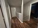 Hallway with wood floors leading to other rooms in home at 2105 Windy Oak Ct, Lithia Springs, GA 30122