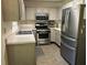 Well-lit kitchen featuring stainless steel appliances and neutral countertops for a modern feel at 2105 Windy Oak Ct, Lithia Springs, GA 30122