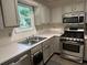 Kitchen with stainless steel appliances, light colored cabinets, and countertops at 2105 Windy Oak Ct, Lithia Springs, GA 30122