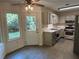 Eat in kitchen offers door to exterior, stainless appliances, neutral countertops and tile flooring at 2105 Windy Oak Ct, Lithia Springs, GA 30122