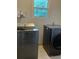Laundry room features a washer and dryer set with a window for natural light at 2105 Windy Oak Ct, Lithia Springs, GA 30122