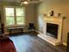 Bright living room featuring hardwood floors, a marble fireplace, and a large window with natural light at 2105 Windy Oak Ct, Lithia Springs, GA 30122