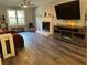 Comfortable living room features a marble fireplace, TV, hardwood flooring, and natural light at 2105 Windy Oak Ct, Lithia Springs, GA 30122