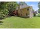 Spacious backyard with a well-maintained lawn, a deck, and mature trees at 2709 Gentry Dr, Douglasville, GA 30135