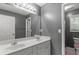 Bathroom featuring double vanity with sink and lighting, mirror, and toilet at 2709 Gentry Dr, Douglasville, GA 30135