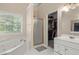 Relaxing bathroom features a soaking tub, separate shower, and vanity with a view to the walk-in closet at 2709 Gentry Dr, Douglasville, GA 30135