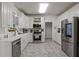 Modern kitchen with stainless steel appliances, white cabinetry and ample counter space at 2709 Gentry Dr, Douglasville, GA 30135
