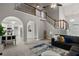Open concept living area with elegant arches, kitchen access, and staircase at 2709 Gentry Dr, Douglasville, GA 30135