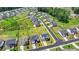 An aerial shot presenting a house surrounded by greenery and other houses, with the road smoothly traversing the neighborhood at 3695 Andover St, Cumming, GA 30028