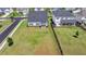 Aerial view of back yard, fence, neighboring houses, and ample green space at 3695 Andover St, Cumming, GA 30028