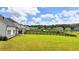 Wide view of back yard featuring large grassy area, and black wooden fence at 3695 Andover St, Cumming, GA 30028