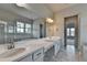 Bright bathroom with double vanity, granite counters, marble floors, and large mirror at 3695 Andover St, Cumming, GA 30028
