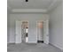 Bright bedroom features ensuite bathroom with gray carpeting at 3695 Andover St, Cumming, GA 30028