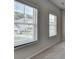 A well-lit bedroom featuring two windows with views of the neighborhood at 3695 Andover St, Cumming, GA 30028