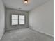 Carpeted bedroom featuring two windows offering ample natural light at 3695 Andover St, Cumming, GA 30028
