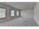 Spacious carpeted bedroom with natural light from two large windows at 3695 Andover St, Cumming, GA 30028