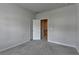 Light filled bedroom with plush carpeting, neutral paint, and a doorway leading to a closet at 3695 Andover St, Cumming, GA 30028