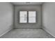 A bedroom with two windows bringing in light to the carpeted floor at 3695 Andover St, Cumming, GA 30028