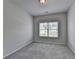 Light filled bedroom featuring neutral paint, plush carpeting, and a window with views of the neighborhood at 3695 Andover St, Cumming, GA 30028