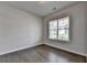 A well-lit bedroom features hardwood floors and a large window, offering a serene space at 3695 Andover St, Cumming, GA 30028