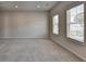 Large carpeted bedroom with abundant natural light from two large windows at 3695 Andover St, Cumming, GA 30028