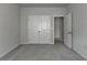 Bedroom featuring closet doors with an open doorway to another room at 3695 Andover St, Cumming, GA 30028