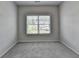 Cozy bedroom with neutral paint, plush carpeting, and a large window providing natural light at 3695 Andover St, Cumming, GA 30028