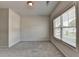 Bright bedroom with plush carpeting and a large window offering natural light and neighborhood views at 3695 Andover St, Cumming, GA 30028