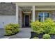 The home's entrance features a striking black front door flanked by vibrant green landscaping at 3695 Andover St, Cumming, GA 30028