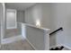 Upper floor hallway featuring plush carpeting, neutral wall paint, and views of the stairway at 3695 Andover St, Cumming, GA 30028